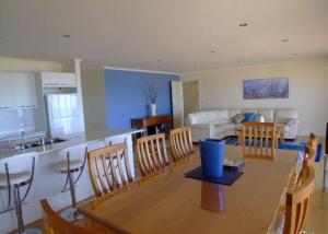 a kitchen and living room with a table and chairs at Elanora Tranquility at Emu Bay in Emu Bay