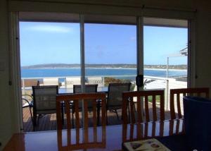 a room with a view of the ocean from a balcony at Elanora Tranquility at Emu Bay in Emu Bay
