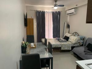a living room with a couch and a table at RF Condotel in Lapu Lapu City +21 photos