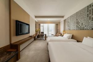 Postel nebo postele na pokoji v ubytování Juntai Hotel Xiamen + 37 fotografií