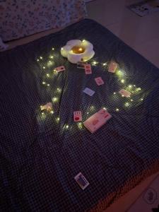 a bed with christmas lights on top of it at Cozynest Homestay n Cinema in Ho Chi Minh City +23 photos