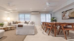 a living room with a couch and a table at Villa 1 Chez Willow Port Douglas in Port Douglas