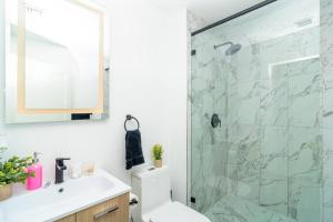 a bathroom with a shower with a toilet and a sink at Stylish Studio Miami Suite Oasis Near Calle Ocho & Brickell in Miami