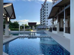 a swimming pool in the middle of a building at Modern Condo, Sea View, Fast Wifi, Cafe, Panglao in Dauis