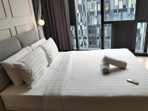 cama blanca grande con mando a distancia en KLCC Star Suites by BBA, en Kuala Lumpur 139 fotos más