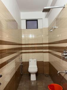 a bathroom with a toilet and a shower and a window at Green valley home stay in Thekkady