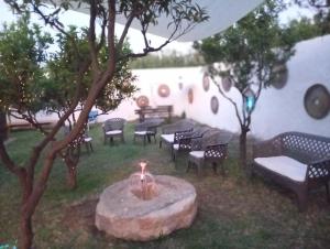 a group of chairs and a fire pit in a yard at Casal Mastro appartamenti e camere con piscina in Bisceglie +38 photos