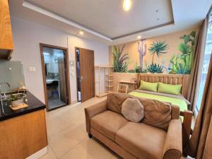 a living room with a couch and a bed at FF Homestay Evy House in Ho Chi Minh City