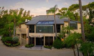 a house with a sign that reads drinks at Sanibel Inn in Sanibel