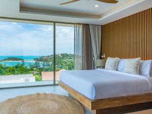 a bedroom with a large bed and a large window at Horizon Villas Samui in Choeng Mon Beach +286 photos