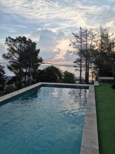 a swimming pool with a view of the water at cardo village in Bastia +1 photo