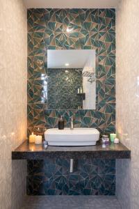 a bathroom with a sink and a mirror at Thalaiva Villa by Hillstayion in Panchgani
