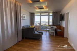 a living room with a couch and a table at 32 Ferienwohnung Baltic Nest App.65-103 in Burgtiefe auf Fehmarn 