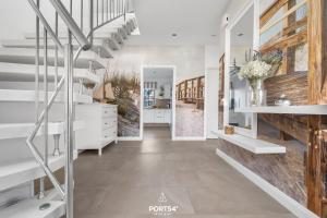 a hallway with a staircase in a house at Ferienhaus Buhne 23 in Büsum +30 photos