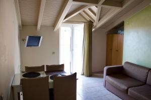 a living room with a couch and a table at Notos Luxury Studios in Katelios