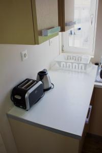 a toaster sitting on a counter in a kitchen at Notos Luxury Studios in Katelios