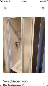 a shower with a glass door in a bathroom at Gästewohnung 25 in Wildeshausen +11 photos