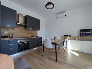 a kitchen with a table and chairs in a room at Maison Lydie in Velletri +11 photos