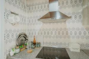 a kitchen with a sink and a stove at La Casa De Sara in Llánaves de la Reina +23 photos