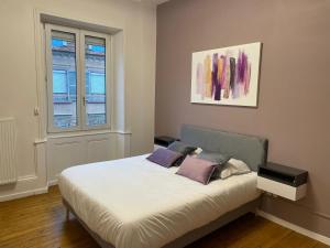una camera da letto con un letto con due cuscini sopra di Hotel-Restaurant St-Christophe a Belfort Altre 70 foto
