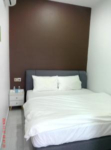 Postel nebo postele na pokoji v ubytování Gemilang Hotel Klang