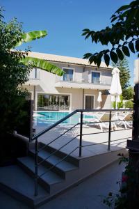 a view of a house with a swimming pool at Notos Luxury Studios in Katelios