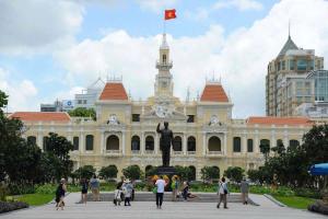 a large building with a statue in front of it at The Passion Suites Hotel & Spa in Ho Chi Minh City