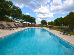 a swimming pool with chaise lounge chairs next to it at Tranquil Getaway with Shared Pool in Bale in Bale