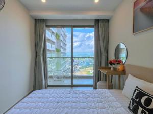 a bedroom with a bed and a large window at The Sóng Vũng Tàu - Thương's Homestay in Vung Tau +162 photos