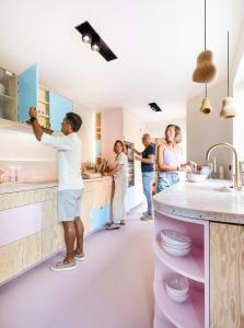 a group of people standing in a kitchen at Villa Plage Ensorpark in Ostend
