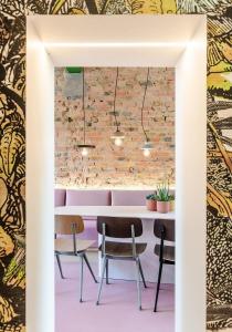 a table and chairs in a room with a brick wall at Villa Plage Ensorpark in Ostend