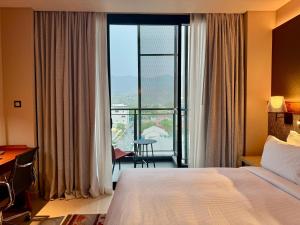 Postel nebo postele na pokoji v ubytování Palm Springs Hotel Dili