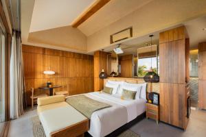 a bedroom with a large white bed and a table at Sini Vie Resort & Spa Seminyak by Ini Vie Hospitality in Seminyak +31 photos