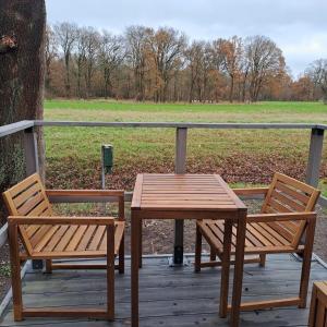 a wooden table and two chairs on a wooden deck at Chalet Stockholm in Bleckede +19 photos