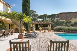 a patio with chairs and a swimming pool at La Bastide de Verez in Vidauban