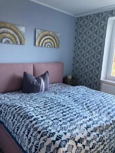a bedroom with a bed and two paintings on the wall at Ferienwohnung Parkentin 3 in Bartenshagen-Parkentin