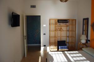a room with a bedroom with a bed and a door at Terrazza Felice in Borgio Verezzi
