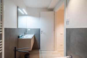 a bathroom with a sink and a mirror at Vittoria Apt Luxury e Design in Duomo in Brescia