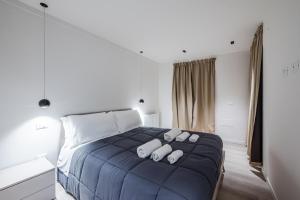 a bedroom with a bed with three pillows on it at Vittoria Apt Luxury e Design in Duomo in Brescia