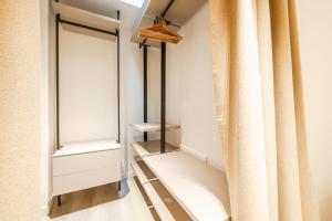 a walk in closet with a mirror and curtains at Vittoria Apt Luxury e Design in Duomo in Brescia +9 photos