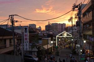 a city street at sunset with a crowd of people at hanare in Tokyo