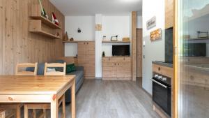 a kitchen and living room with a couch and a table at Italianway - Belvedere 28 - Stella Bianca in Valdidentro