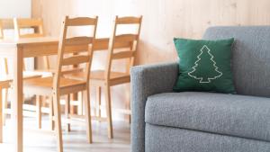a blue chair with a green pillow with a christmas tree on it at Italianway - Belvedere 28 - Stella Bianca in Valdidentro