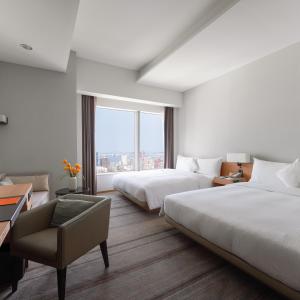 Postel nebo postele na pokoji v ubytování Hotel COZZI Zhongshan Kaohsiung