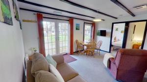 a living room with a couch and a table at 14 Tudor Court, Tolroy Manor in Hayle