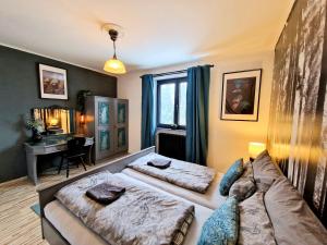 a living room with a couch and a bed at Alp Haus Grossglockner in Bruck an der Großglocknerstraße