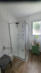 a bathroom with a shower with a glass door at Ma petite maison, non accessible aux personnes à mobilité réduite in Acquigny +13 photos