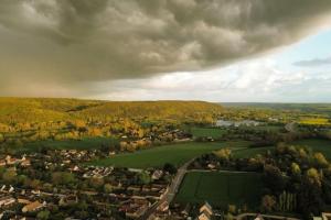 an aerial view of a town with a green field at Ma petite maison, non accessible aux personnes à mobilité réduite in Acquigny