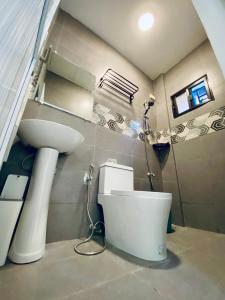 a bathroom with a toilet and a sink at FYLL Homes Ysabella Suite Calvario St Cavinti Town Proper in Cavinti