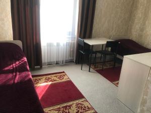 a room with a table and chairs and a window at STAR MEN in Karagandy